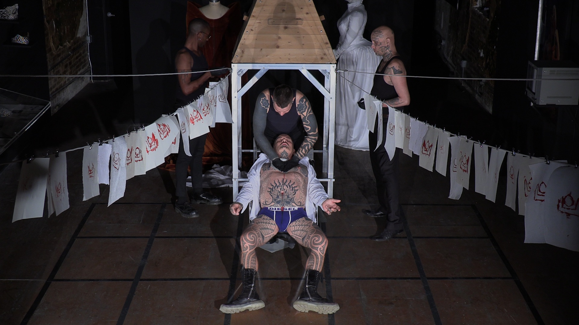 Ron Athey with Hermes Pittakos, Mecca, and Elliot Reed, *Performance at Participant in 3 Acts*, 2021. Video still: Glen Fogel. As part of *Queer Communion: Ron Athey*, curated by Amelia Jones, Participant Inc, New York, 2021.