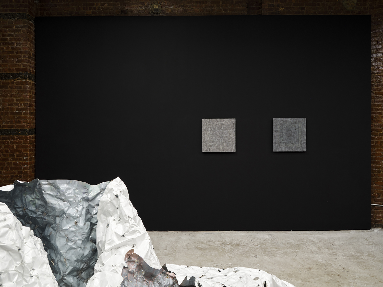 *arms ache avid aeon: Nancy Brooks Brody / Joy Episalla / Zoe Leonard / Carrie Yamaoka: fierce pussy amplified: Chapter Eight*, Curated by Jo-ey Tang, 2025, installation view at Participant Inc, NYC, pictured: Joy Episalla, *foldtogram (chromo white/blue, winter 40’ x 50”)*, 2025, light sensitive chromogenic object, and Nancy Brooks Brody, *Glory Hole*, (vibgyor) white on black, 2012, oil on Venetian plaster on wood, and Nancy Brooks Brody *Glory Hole*, (vibgyor) grey on black, 2018, oil on venetian plaster on wood. Photos by Studio Kukla
